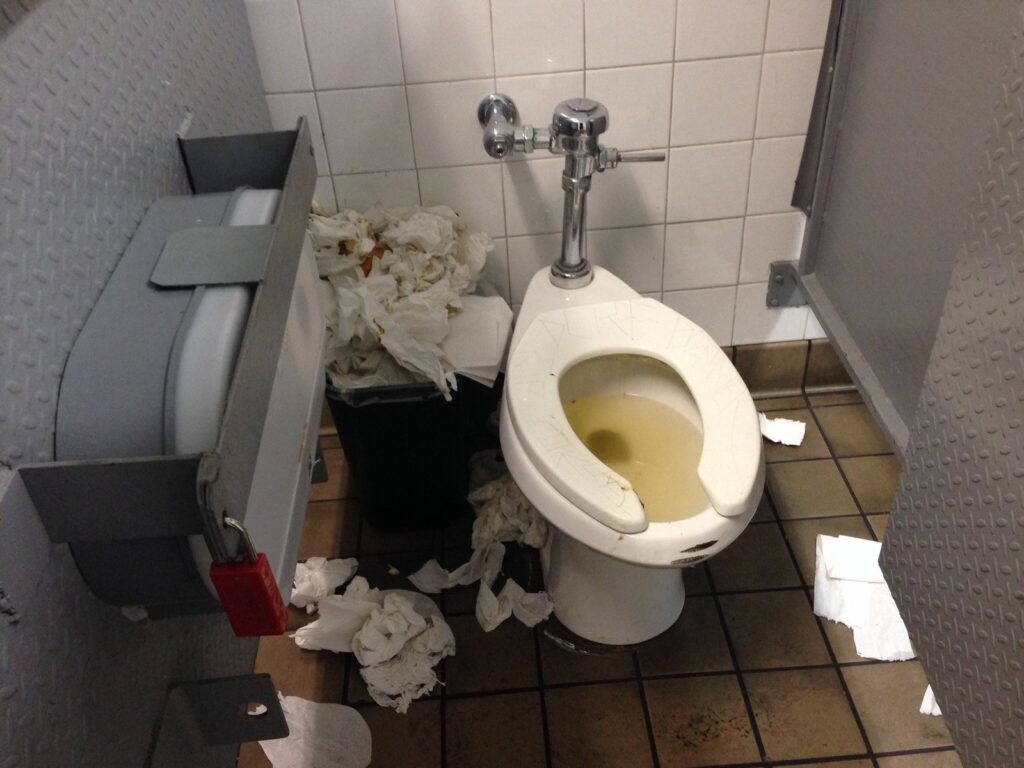 A clean bathroom in Mexico with a wastebasket placed beside the toilet bowl.