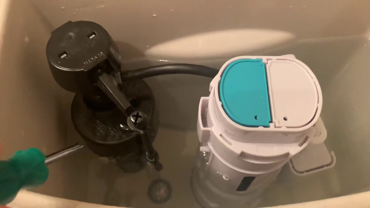 A worn rubber flapper inside a toilet tank causing water to leak.
