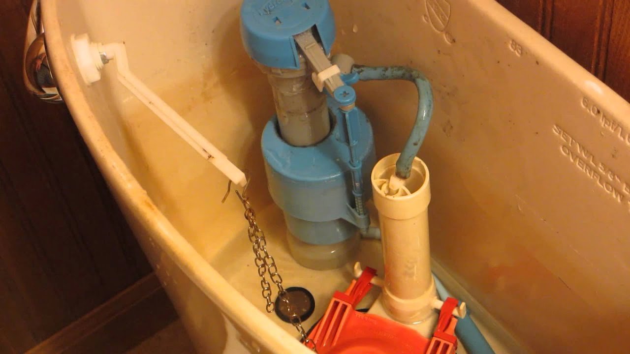 A disconnected refill tube inside a toilet tank causing improper water flow.