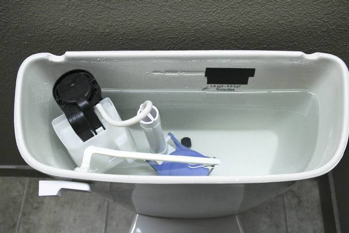 Plumbing tools organized on a towel next to a bathroom vanity.